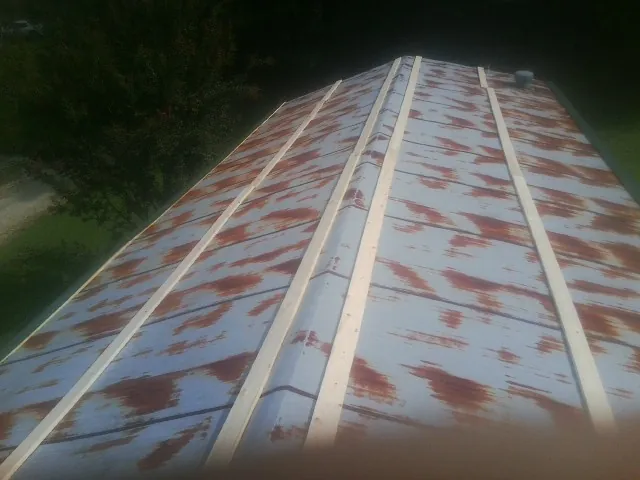 Rusted metal roof panels with new wood purlins before replacement — Storm Damage Roof Repair in Saugatuck by Roofing Brothers
