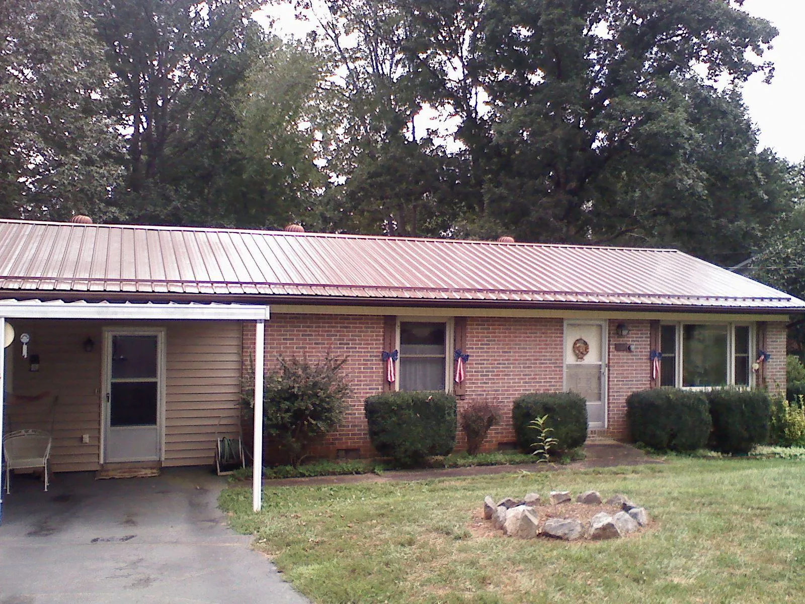 Bronze metal roof and carport on a brick ranch home — Roof Repair work by our crew in Saugatuck