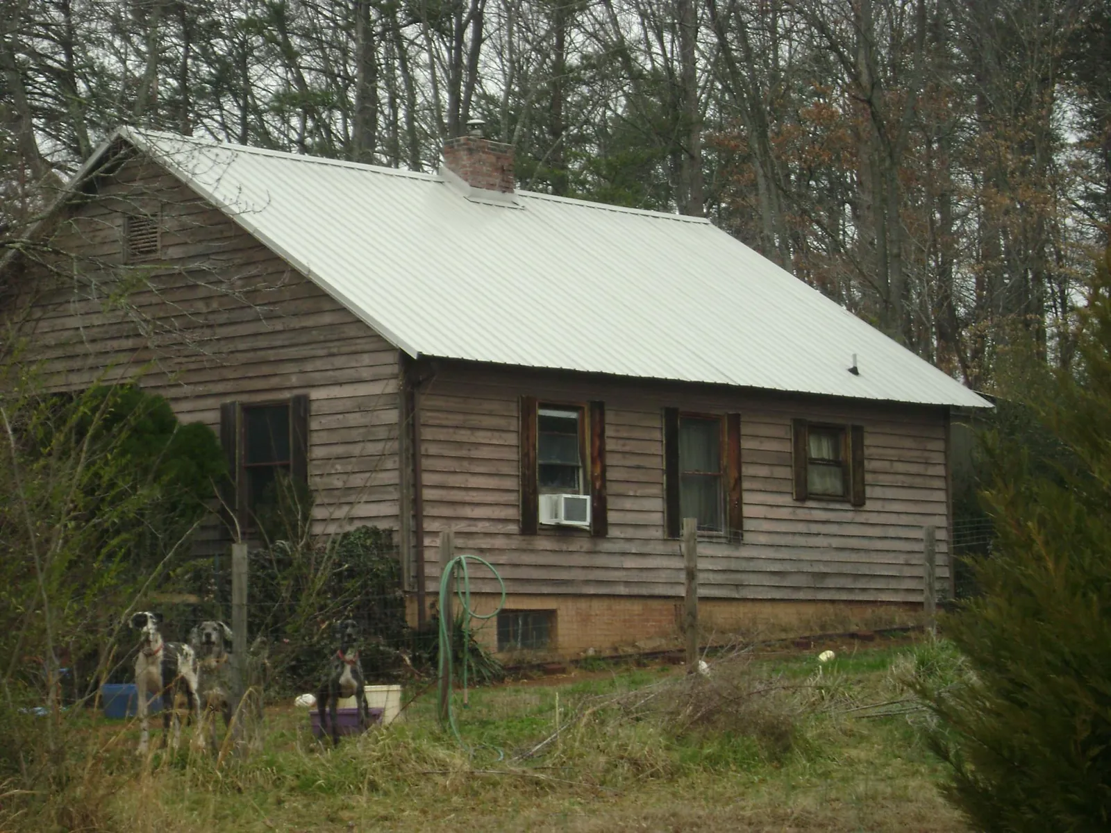 White metal roof on an old wood sided farmhouse, from a Metal Roof Installation job in Saugatuck